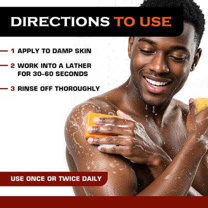 Black man using an orange soap bar on his shoulder in the shower with lather, alongside directions to use: apply to damp skin, work into a lather for 30–60 seconds, rinse off thoroughly, use once or twice daily.